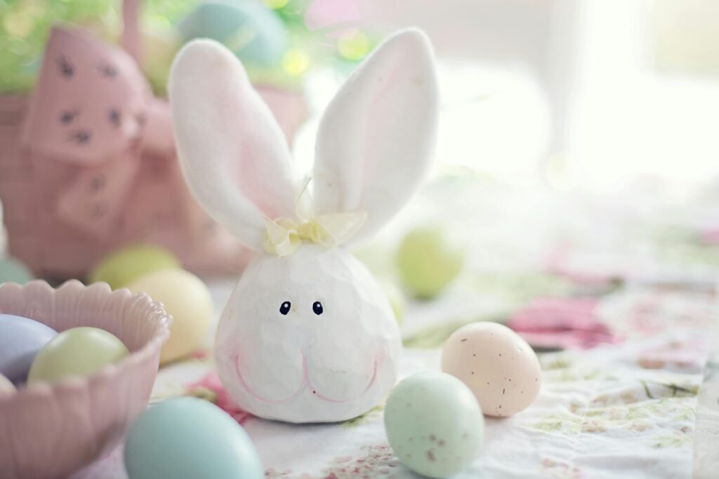 Smart Easter Gift Ideas for Kids. Category under Thoughtful Gift Ideas For Every Occasion. Charming Easter setup featuring a bunny decoration and pastel eggs on a floral tablecloth.
